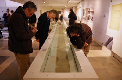 Visitors looking at the 'On The Road' scroll in it's case