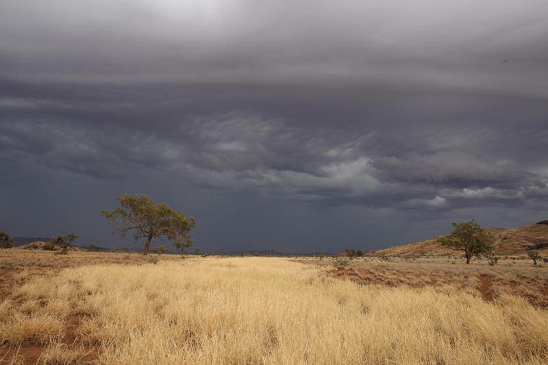 Dark grey clouds over a dry landscape