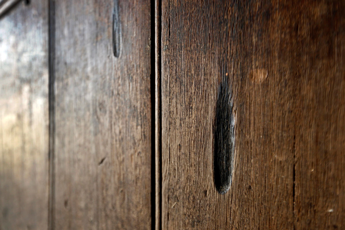 A burn mark on a brown wood