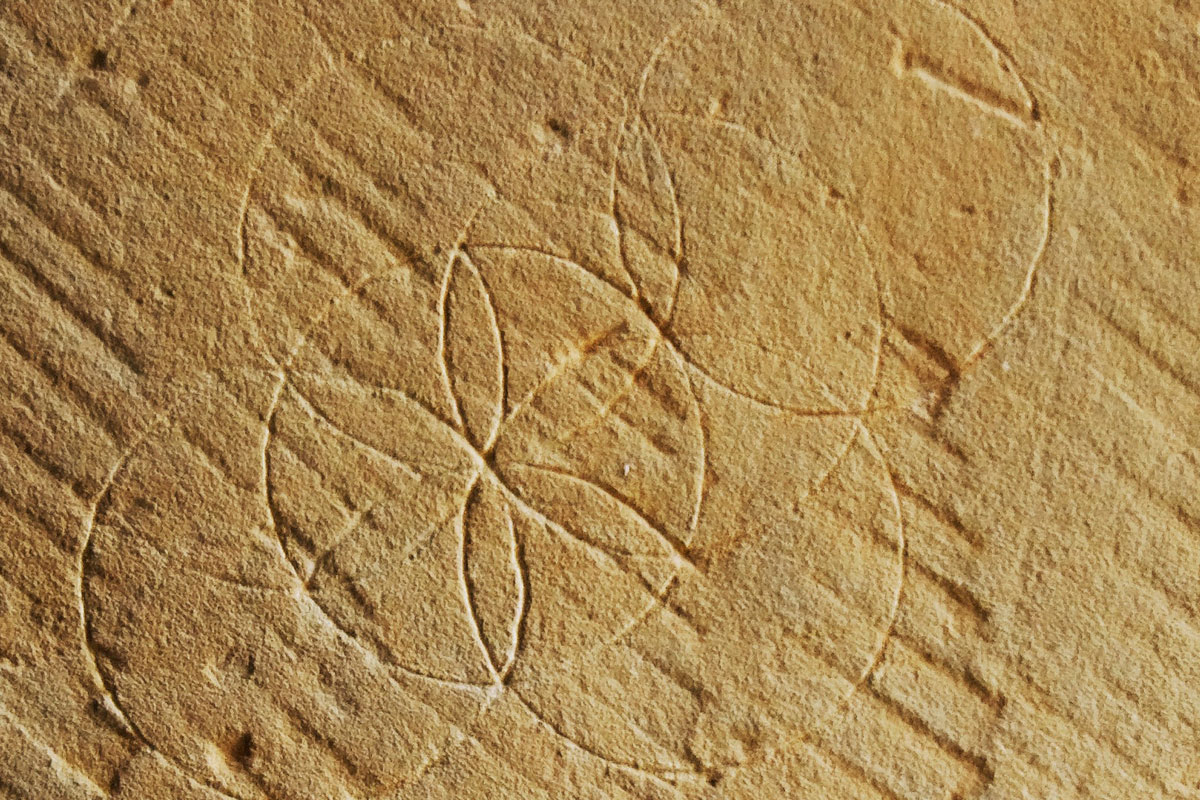 A circular geometric carving in a stone wall
