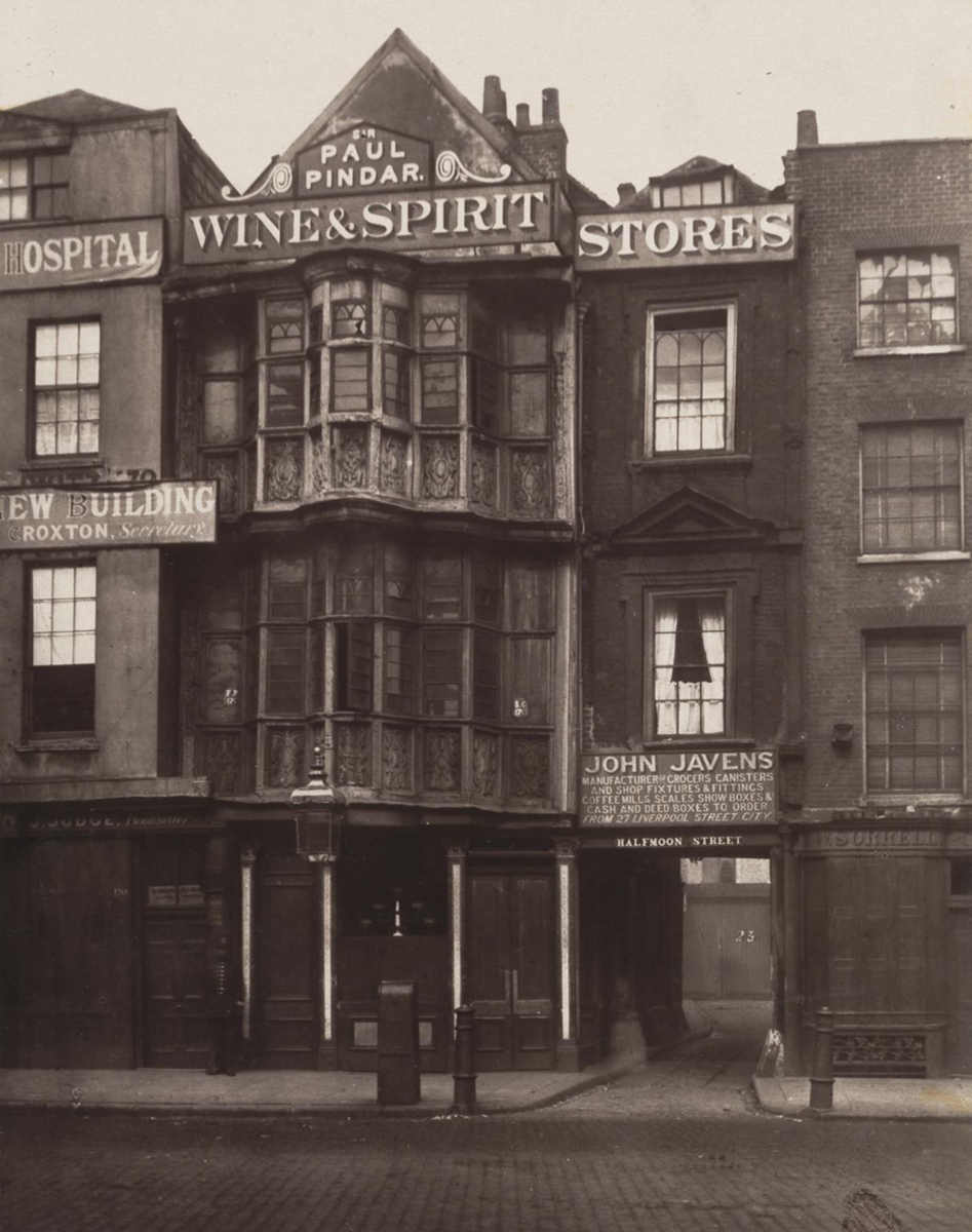 A 19th Cenutry photograph of a shopfront with ornate carved wood details
