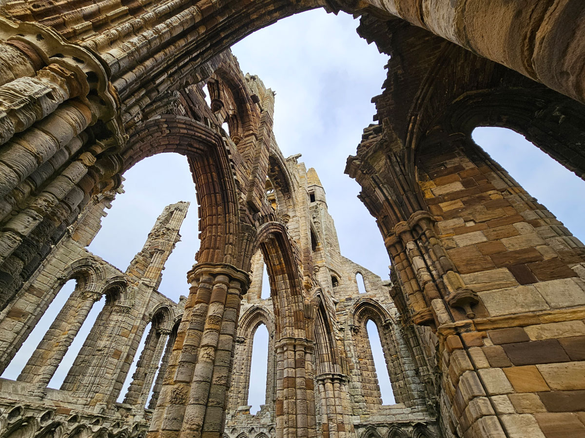 Looking up through the open roof of a ruined church building