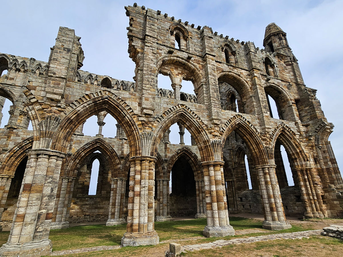 A view of the side of a ruined church building, which has no roof