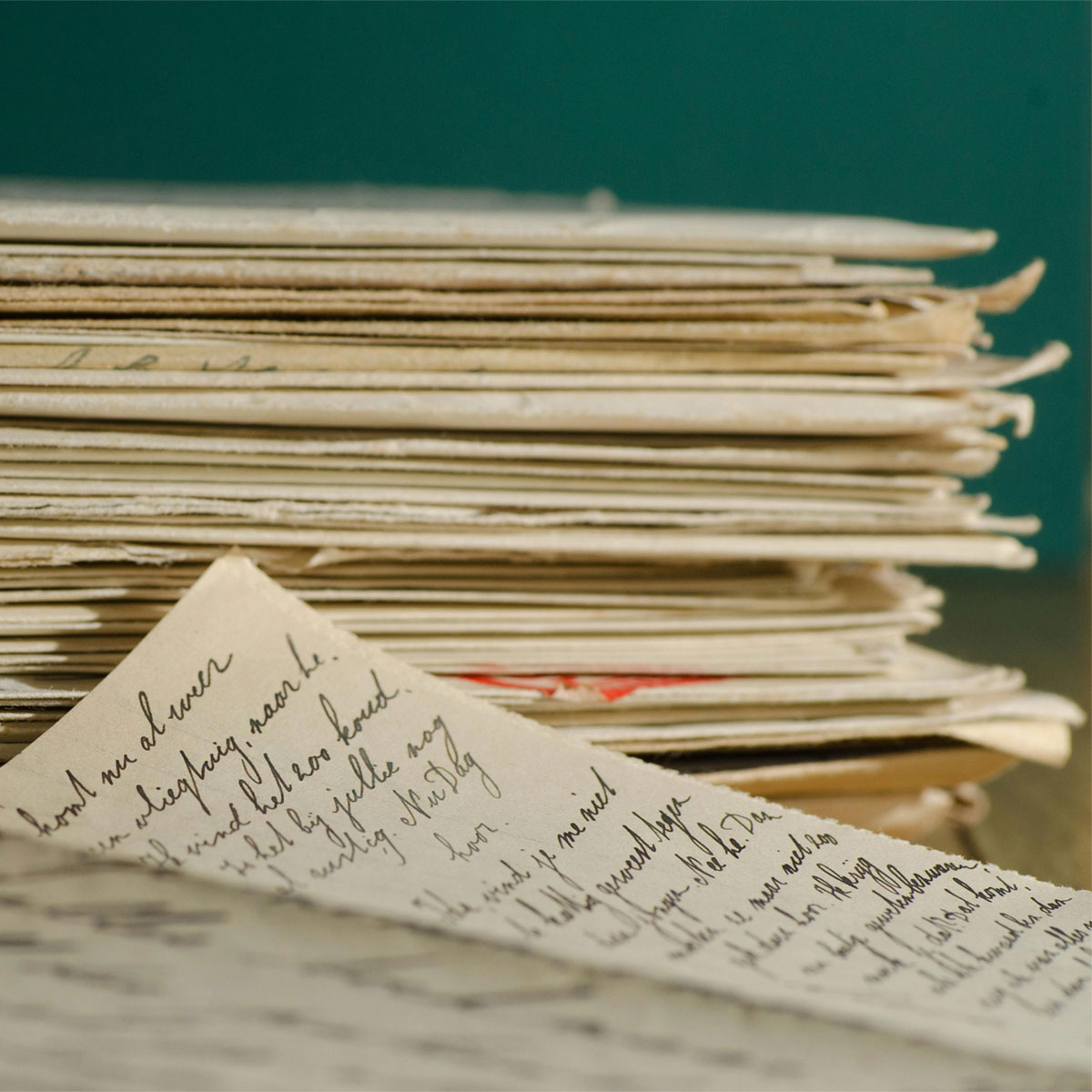 A letter on a table in front of a pile of document folders