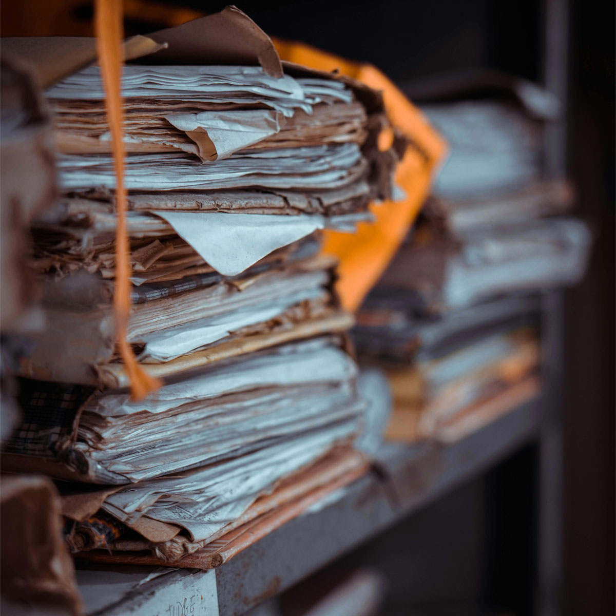 Folders full of papers stacked on shelves