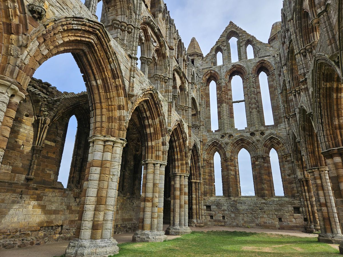 Part of the ruin of an old abbey, with gras where the floor used to be, and no roof.