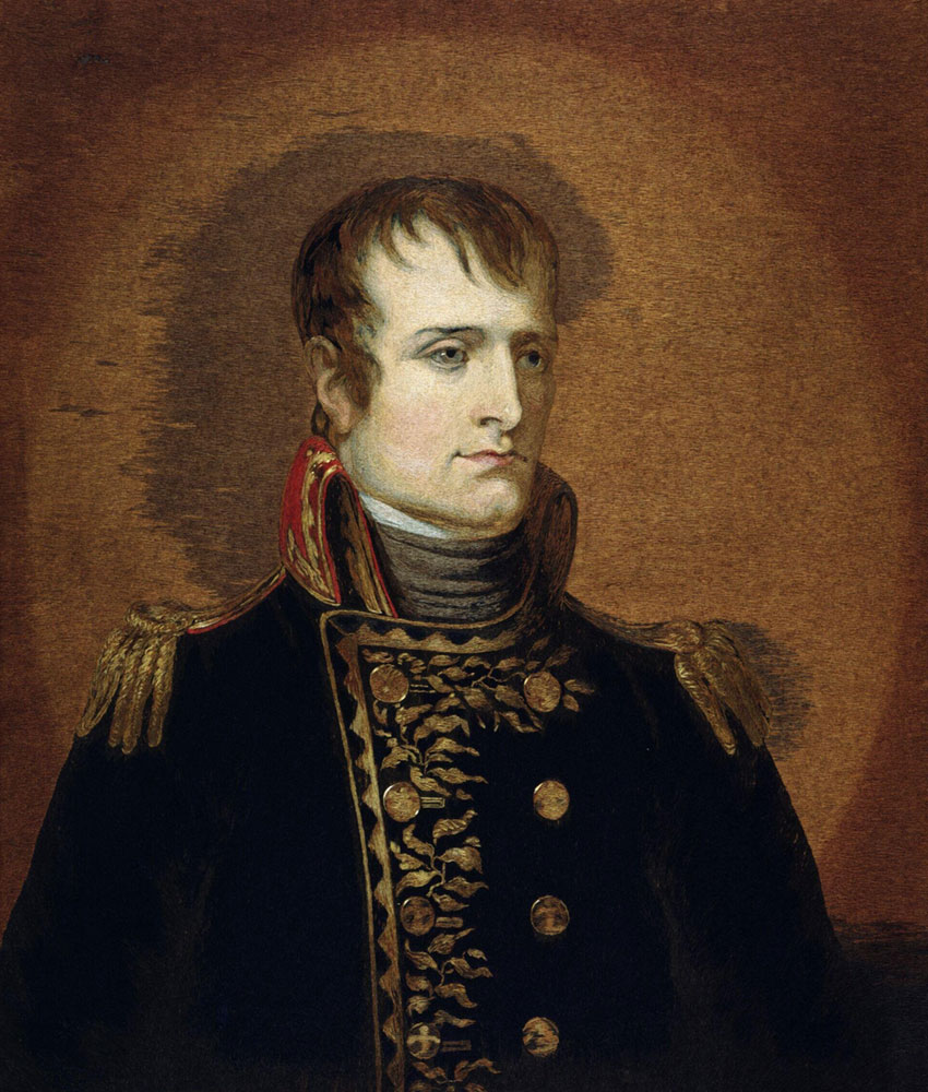 An embroidered portrait of the head and shoulders of Napoleon Bonaparte. He's wearing a military uniform and is against a brown background.