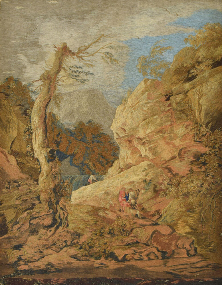 An embroidered landscape scene featuring a person walking between a tree and a mountain.